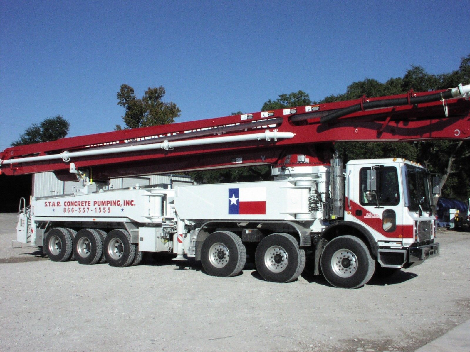 S.T.A.R. 58 meter Putzmeister boom pump, side view, Texas flag on the deck