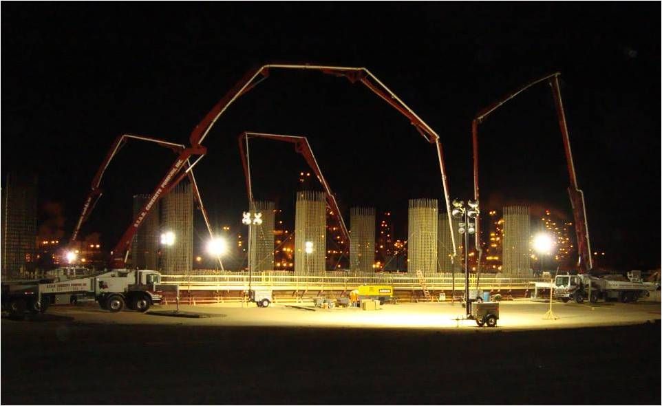 Five S.T.A.R. booms arched over a floodlit night pour