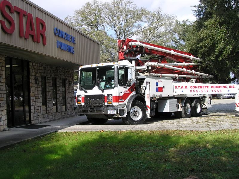 S.T.A.R. boom pump truck in front of the STAR Concrete Pumping office in Tomball